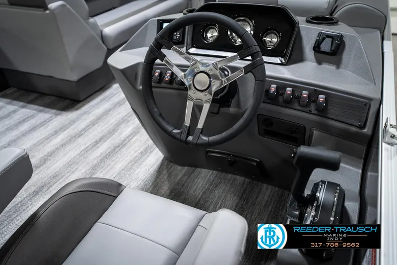 Slide: The Image of 2025 Bennington 21 SLJ boat dashboard with steering wheel and controls, featuring modern design. - 34