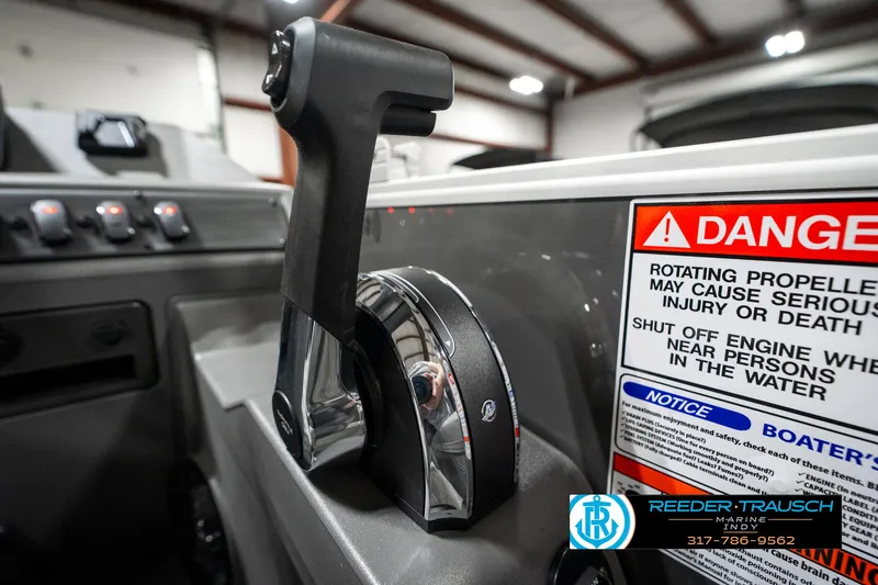 Slide: The Image of Throttle control of 2025 Bennington 21 SLJ boat with safety warning labels. - 42