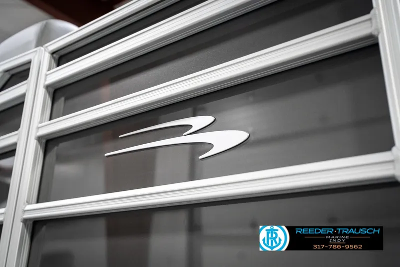 Slide: The Image of 2025 Bennington 21 SLJ boat exterior with logo, showcased by Reeder-Trausch Marine. - 49