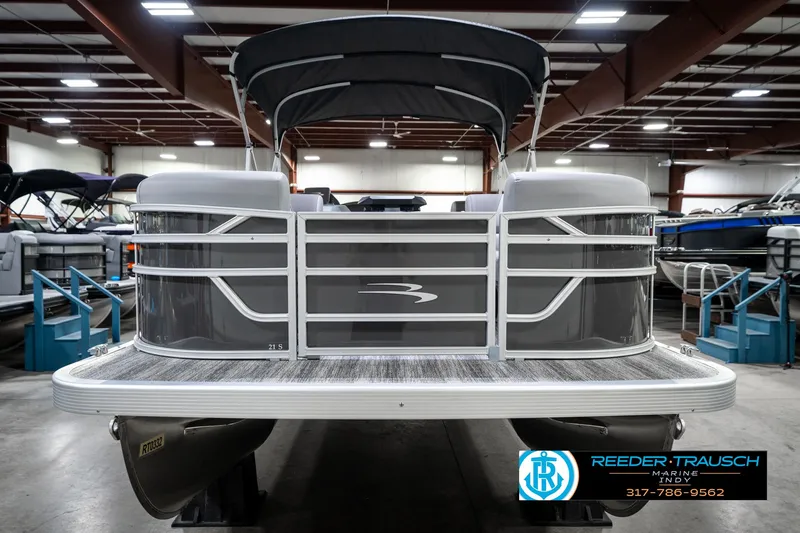 Slide: The Image of 2025 Bennington 21 SLJ pontoon boat in showroom, front view, with canopy. - 5