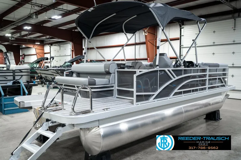 Slide: The Image of 2025 Bennington 21 SLJ pontoon boat in showroom with canopy and seating. - 8