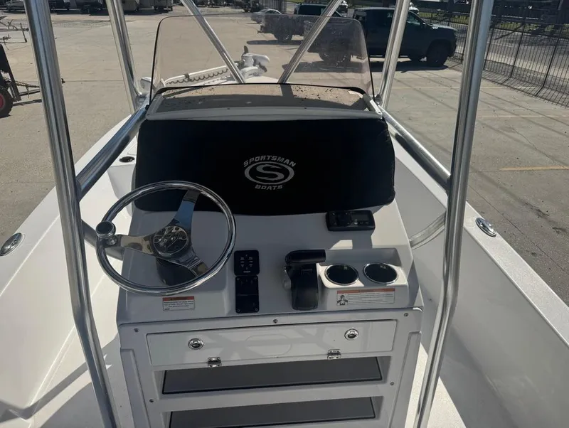 Slide: The Image of 2021 Sportsman Tournament 234 SBX Bay Boat console with steering wheel and controls. - 10