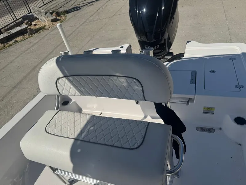 Slide: The Image of 2021 Sportsman Tournament 234 SBX Bay Boat with cushioned seating and outboard motor. - 12