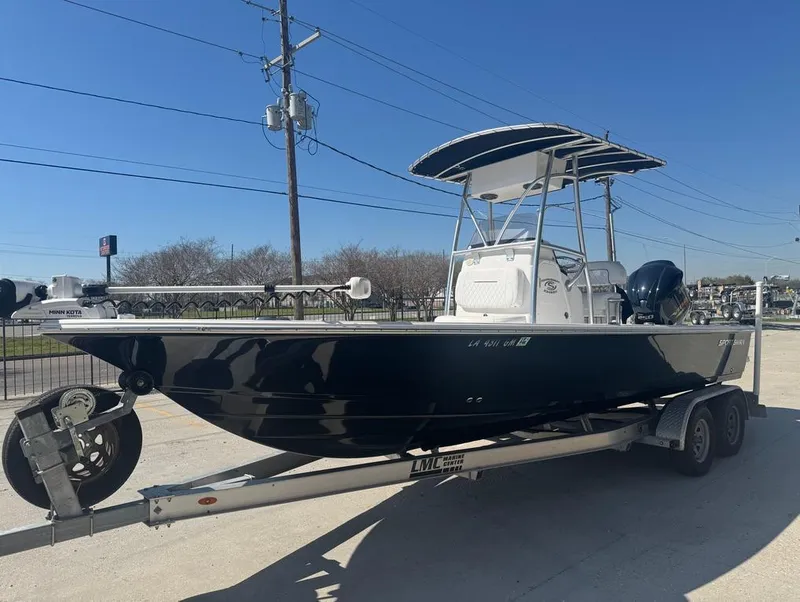 Slide: The Image of 2021 Sportsman Tournament 234 SBX Bay Boat on trailer, parked outdoors under clear sky. - 3
