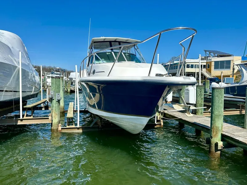 Slide: The Image of 2005 Stamas 320 Express boat docked at a marina on a sunny day. - 1
