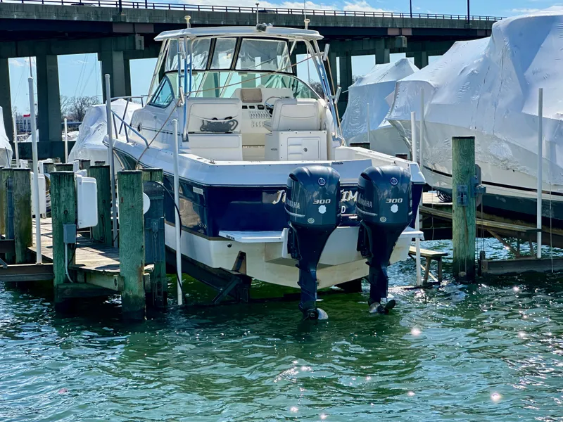 Slide: The Image of 2005 Stamas 320 Express boat docked with twin Yamaha outboard engines. - 10