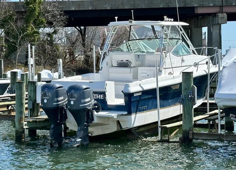 Slide: The Image of 2005 Stamas 320 Express boat docked with twin Yamaha engines. - 11