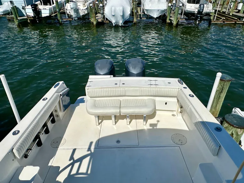 Slide: The Image of 2005 Stamas 320 Express boat with spacious deck and dual engines at a marina. - 16
