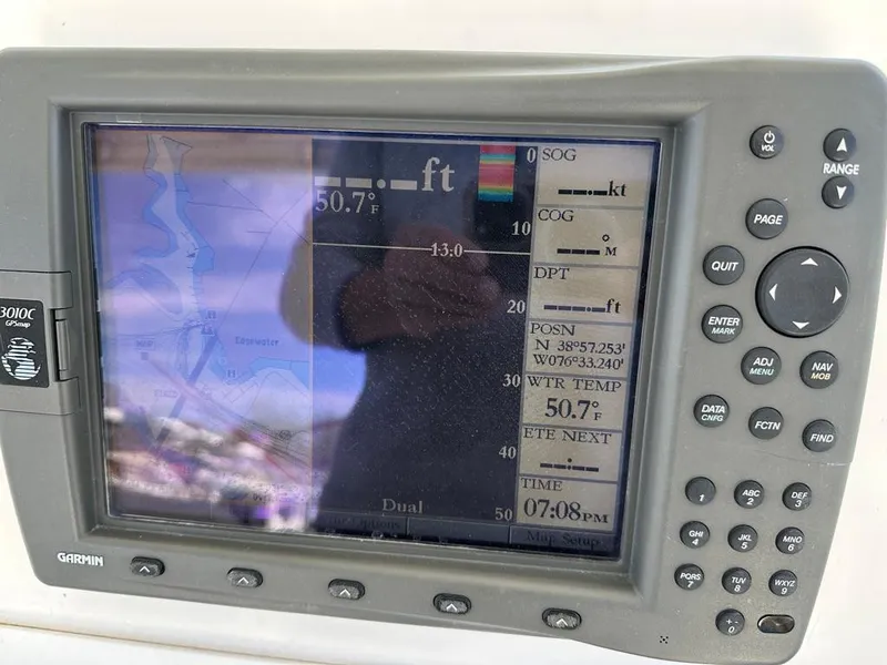 Slide: The Image of Garmin GPS display on a 2005 Stamas 320 Express boat showing navigation data. - 23