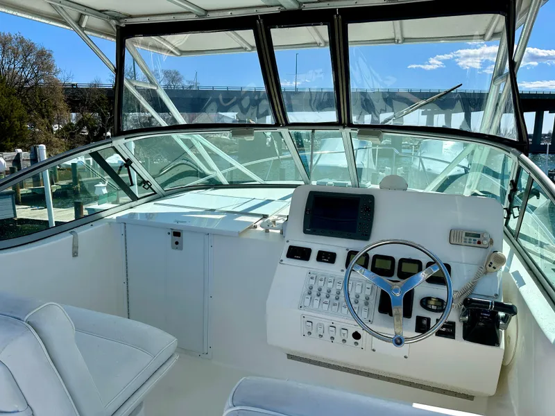 Slide: The Image of 2005 Stamas 320 Express boat cockpit with steering wheel and navigation controls. - 24