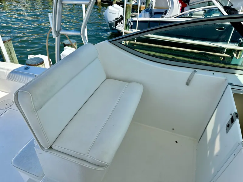 Slide: The Image of 2005 Stamas 320 Express boat seating area with white upholstery. - 26