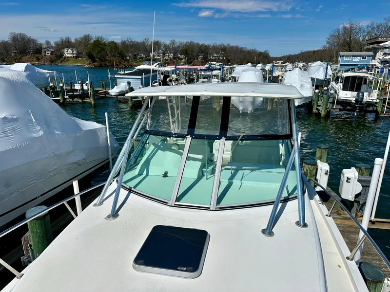 Slide: The Image of 2005 Stamas 320 Express boat docked at a marina on a sunny day. - 31