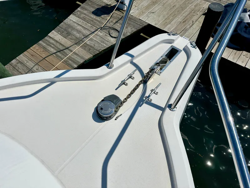 Slide: The Image of 2005 Stamas 320 Express boat bow with anchor chain and dock view. - 32