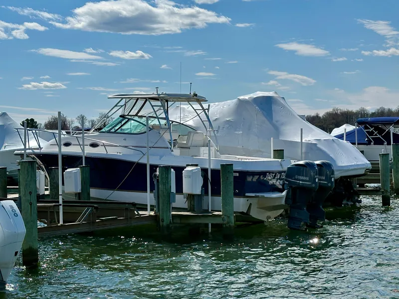 Slide: The Image of 2005 Stamas 320 Express boat docked in marina under clear blue sky. - 4
