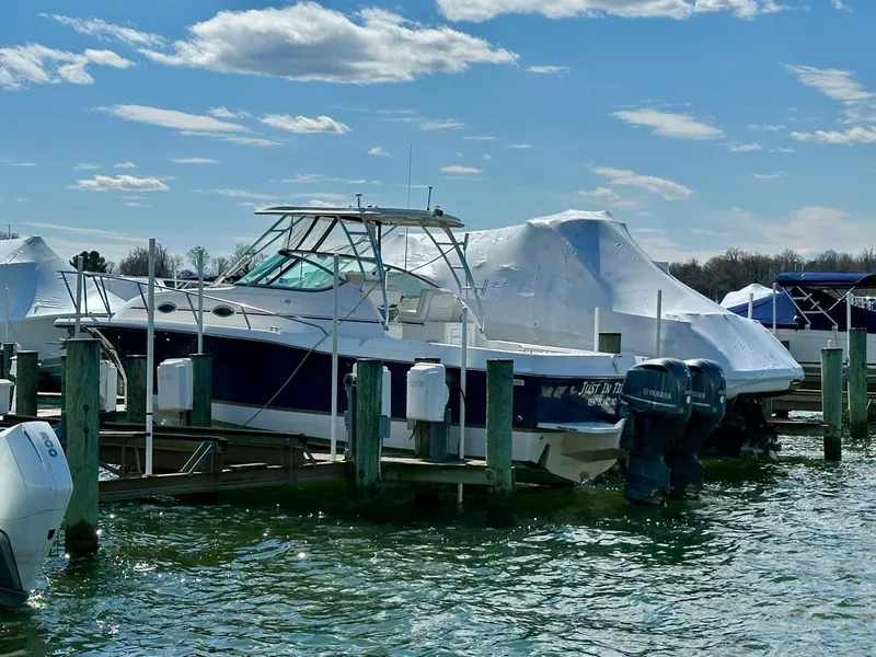 Slide: The Image of 2005 Stamas 320 Express boat docked at marina under blue sky. - 5
