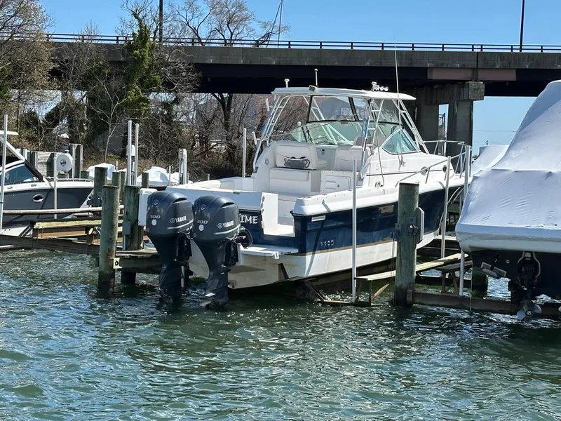 Slide: The Image of 2005 Stamas 320 Express boat docked with twin Yamaha outboard engines. - 9