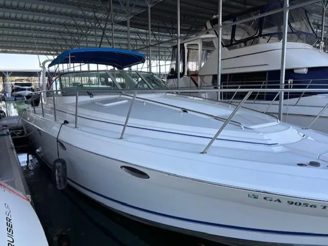 Slide: The Image of 1997 Formula 34PC boat docked in a marina under a covered structure. - 1