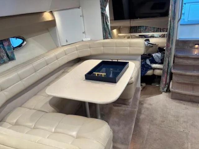 Slide: The Image of Interior of a 1997 Formula 34PC yacht with beige seating and a table. - 14