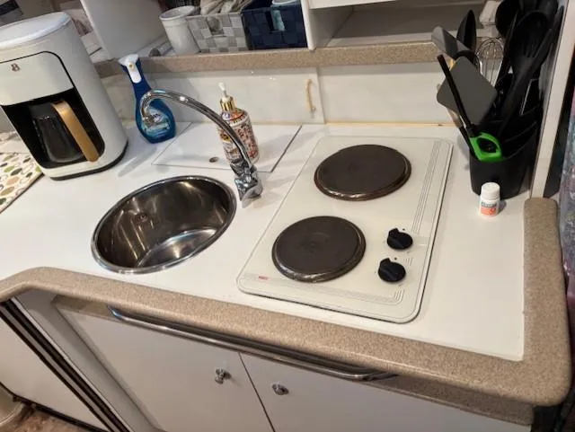 Slide: The Image of 1997 Formula 34PC boat kitchenette with sink, stove, and coffee maker. - 15