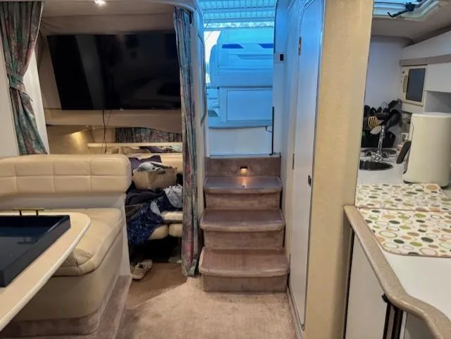 Slide: The Image of Interior of a 1997 Formula 34PC boat with seating, stairs, and kitchenette. - 17