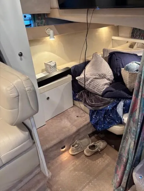 Slide: The Image of Interior of a 1997 Formula 34PC boat with cozy bedding and ambient lighting. - 18
