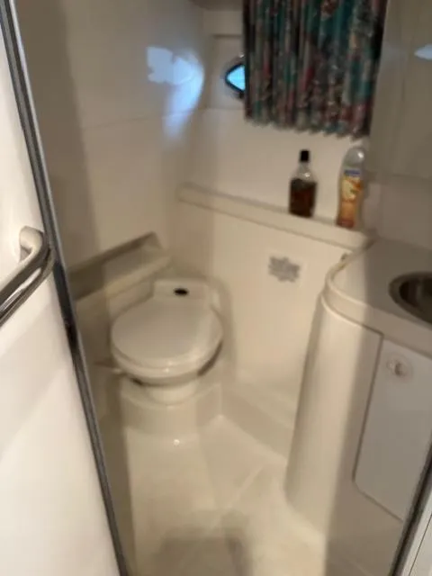 Slide: The Image of 1997 Formula 34PC boat bathroom with toilet, sink, and toiletries. - 19