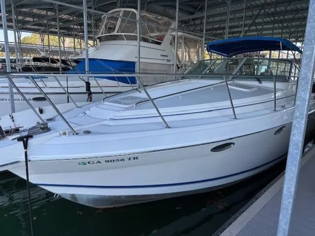 Slide: The Image of 1997 Formula 34PC boat docked in a marina under a covered structure. - 2