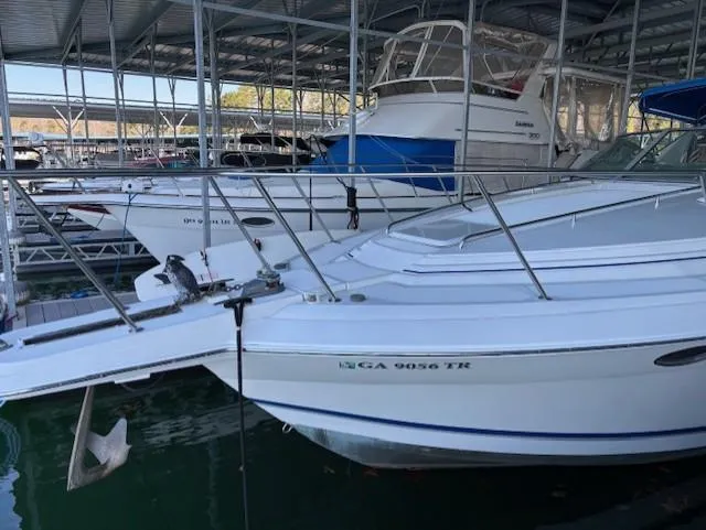 Slide: The Image of 1997 Formula 34PC boat docked in a marina, surrounded by other vessels. - 3