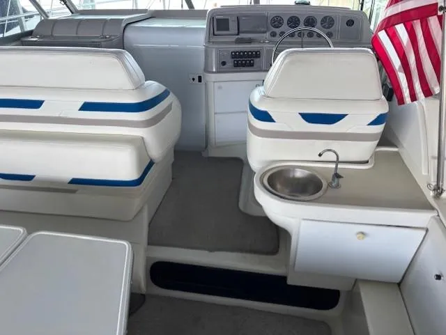 Slide: The Image of 1997 Formula 34PC boat interior with seating, steering console, and sink. - 7
