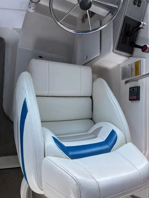 Slide: The Image of 1997 Formula 34PC boat cockpit with white and blue seating and steering wheel. - 9
