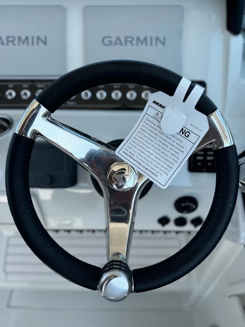 Slide: The Image of Steering wheel of 2024 Finseeker 245 WA boat with Garmin navigation system. - 11