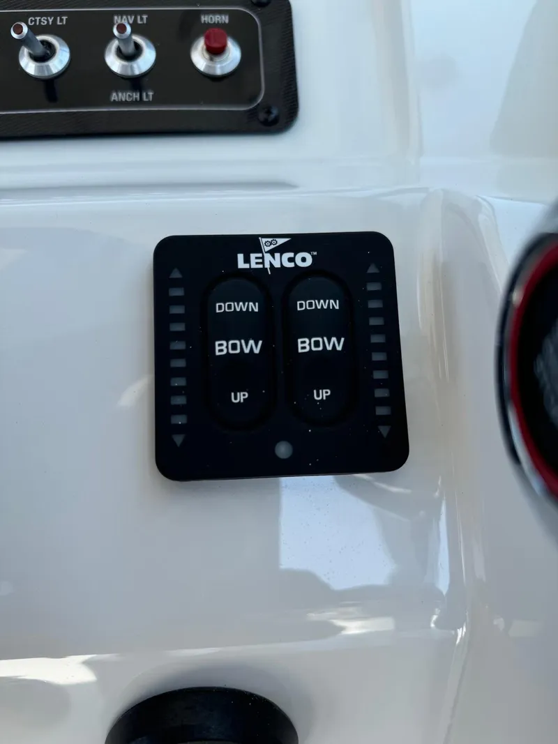 Slide: The Image of Control panel of 2024 Finseeker 245 WA boat with Lenco trim tab switches. - 13