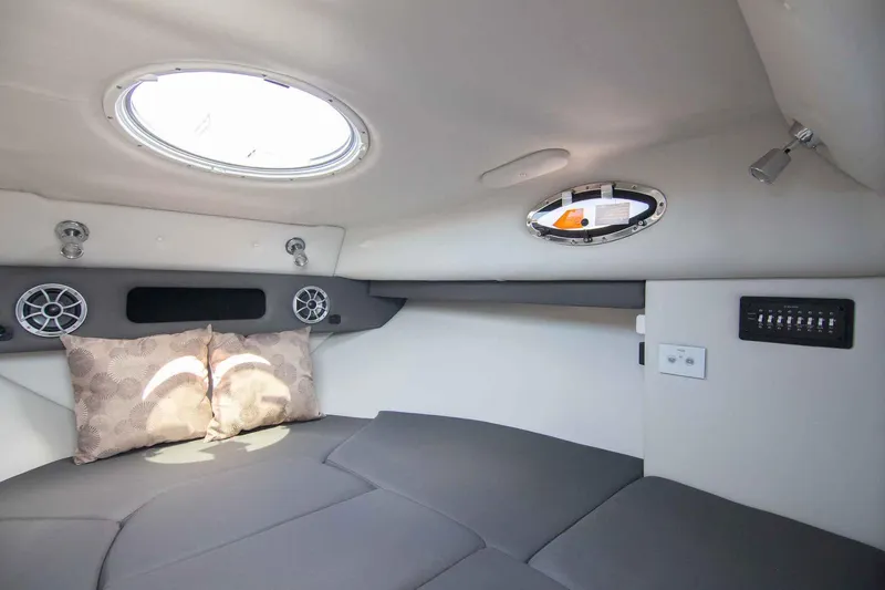 Slide: The Image of 2024 Finseeker 245 WA cabin interior with cushions, speakers, and portholes. - 14
