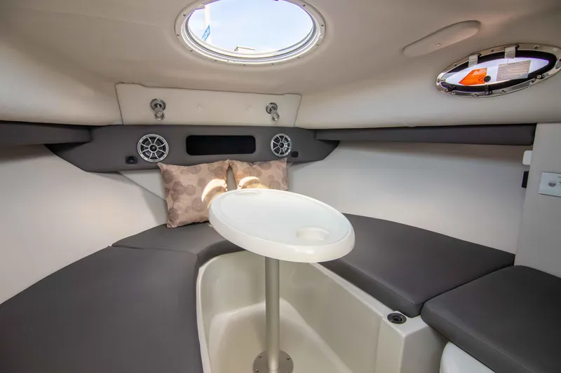 Slide: The Image of 2024 Finseeker 245 WA cabin interior with seating, table, and porthole. - 15