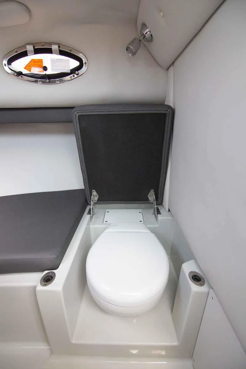 Slide: The Image of 2024 Finseeker 245 WA boat interior with compact marine toilet. - 18