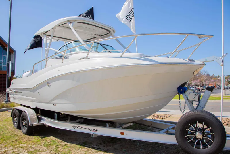 Slide: The Image of 2024 Finseeker 245 WA boat on trailer, displayed outdoors with flags. - 20