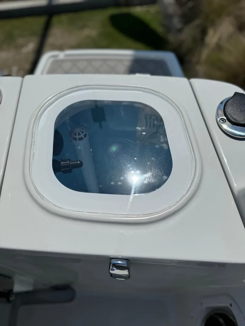 Slide: The Image of 2024 Finseeker 245 WA boat detail with a small window and control panel. - 7