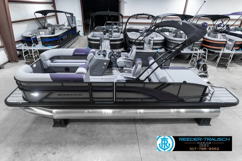 Slide: The Image of 2025 Bennington 21 SSB pontoon boat in showroom, featuring sleek design and modern amenities. - 1
