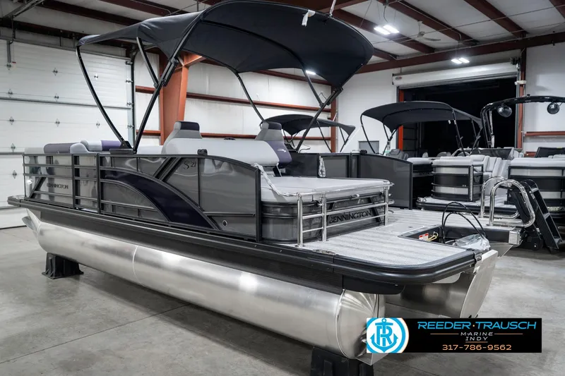 Slide: The Image of 2025 Bennington 21 SSB pontoon boat in showroom, featuring sleek design and spacious seating. - 10