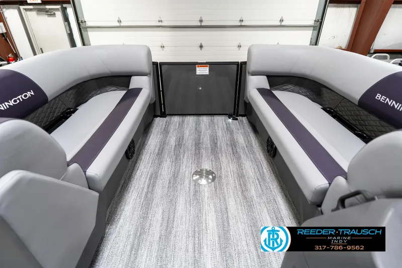 Slide: The Image of 2025 Bennington 21 SSB interior with gray seating and flooring in a showroom. - 21