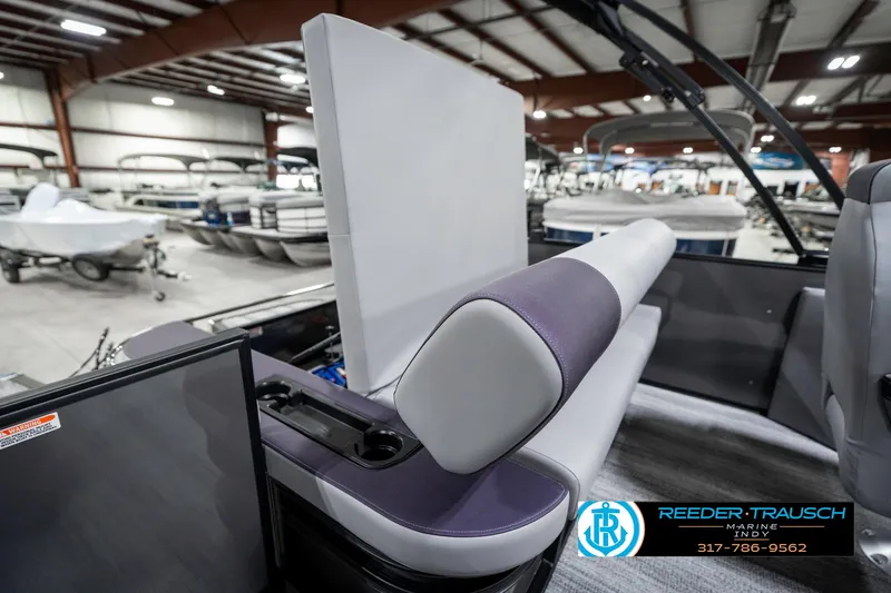 Slide: The Image of 2025 Bennington 21 SSB boat interior with gray and purple seating in showroom. - 27