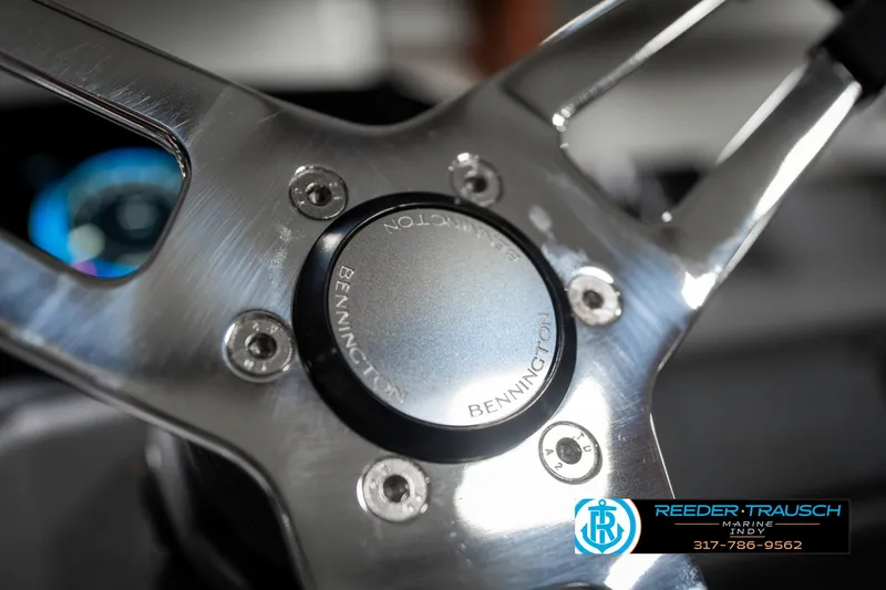 Slide: The Image of Steering wheel of 2025 Bennington 21 SSB boat, featuring sleek metallic design. - 34