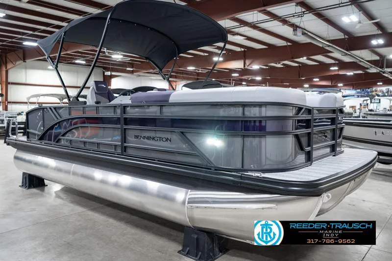 Slide: The Image of 2025 Bennington 21 SSB pontoon boat in showroom with canopy and sleek design. - 6