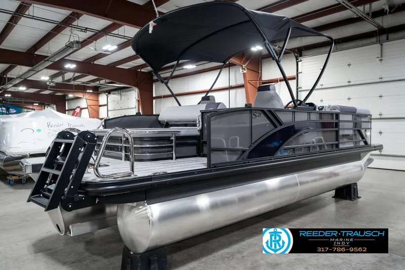 Slide: The Image of 2025 Bennington 21 SSB pontoon boat in showroom with canopy and modern design. - 7