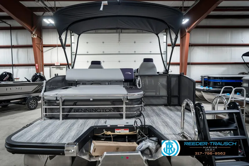 Slide: The Image of 2025 Bennington 21 SSB pontoon boat in showroom, featuring sleek design and modern amenities. - 9