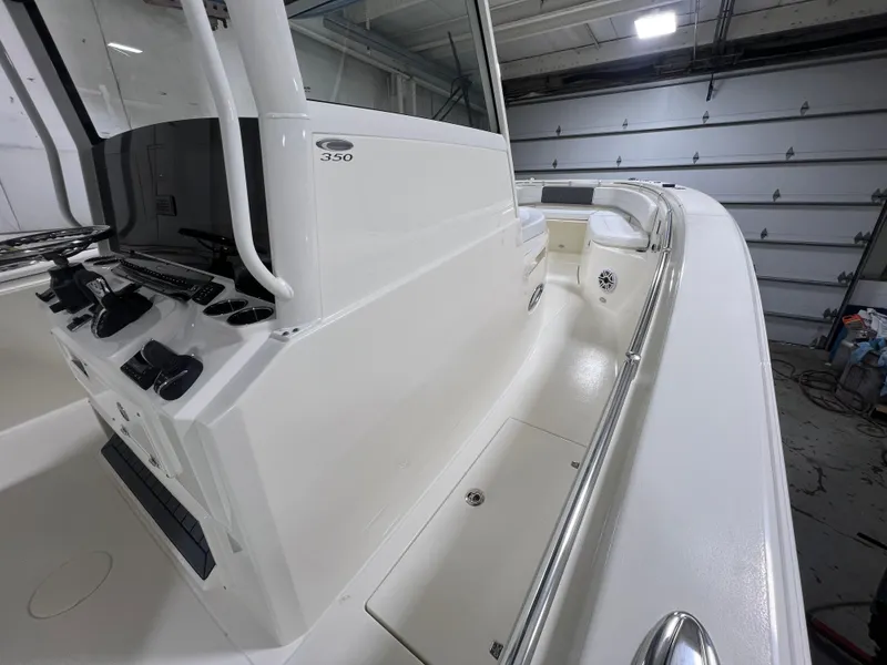 Slide: The Image of 2025 Cobia 350 Center Console boat interior in a garage setting. - 13