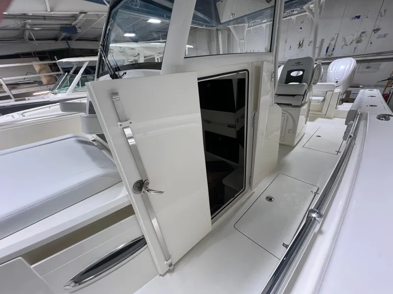 Slide: The Image of 2025 Cobia 350 Center Console boat interior with open storage compartment. - 15