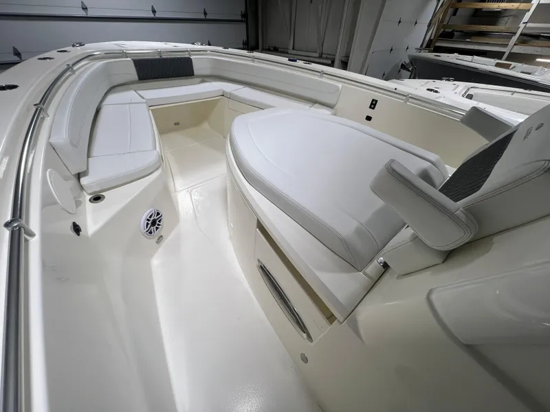 Slide: The Image of 2025 Cobia 350 Center Console boat interior with white seating and modern design. - 17
