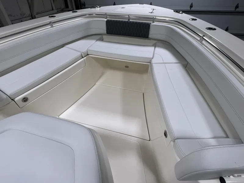 Slide: The Image of 2025 Cobia 350 Center Console boat interior with white cushioned seating. - 18