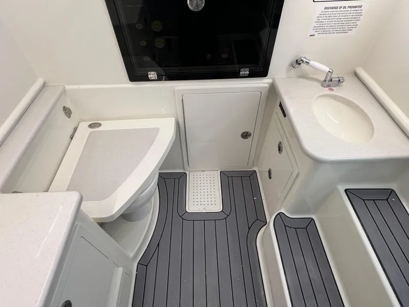 Slide: The Image of 2025 Cobia 350 Center Console boat bathroom with modern fixtures and gray flooring. - 21